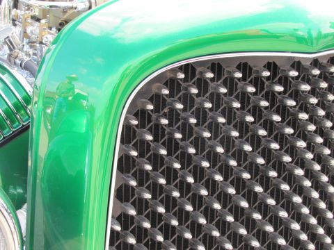 2006 BMW 5 Series - A detailed view of a custom hot rod's front end, highlighting its unique grille and polished engine components.