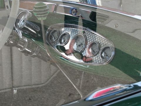 2006 BMW 5 Series - The interior of a vehicle features a custom dashboard with multiple gauges and a distinctive green striped gear shift knob.