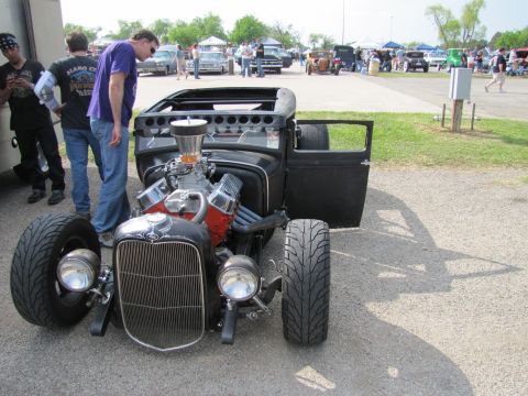 2006 BMW 5 Series - A custom hot rod with a powerful engine is on display at an outdoor event.