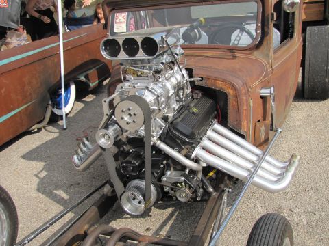 2006 BMW 5 Series - Custom hot rod pickup truck features a prominent supercharged V8 engine and exposed exhaust system.