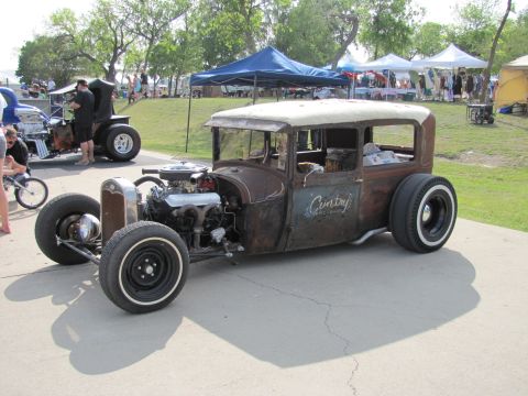 2006 BMW 5 Series - A custom hot rod with a weathered exterior and a powerful engine is on display.