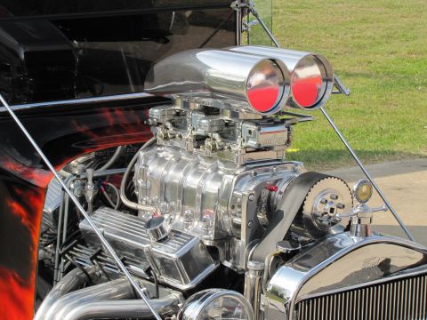 2006 BMW 5 Series - Close-up of a highly polished V8 engine a prominent supercharger and dual carburetors.
