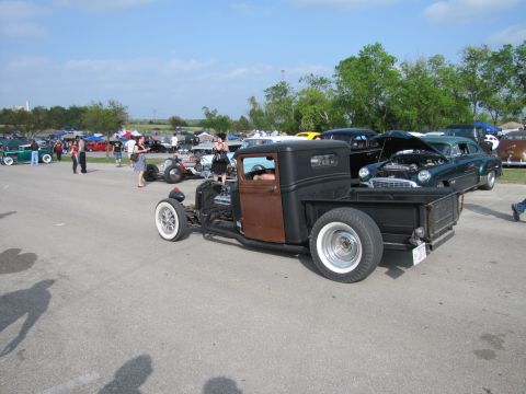 2006 BMW 5 Series - Outdoor car show features a custom hot rod pickup truck alongside other vintage automobiles.