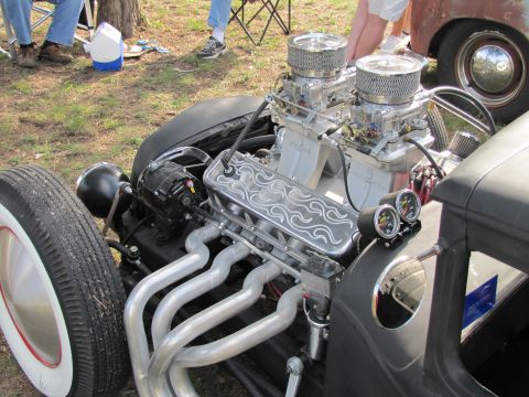 2006 BMW 5 Series - A custom hot rod engine features dual carburetors, polished exhaust headers, and unique valve covers with a flame design.