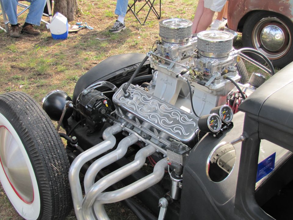 Hot rod engine with dual carburetors, custom flame valve covers, and exhaust headers