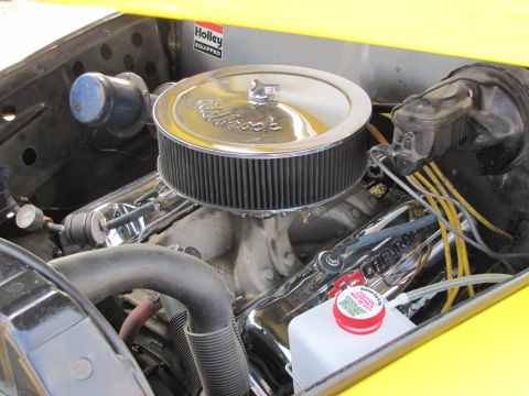 2006 BMW 5 Series - Close-up view of a vehicle's engine bay, a Holley air cleaner and Chevrolet branded valve covers.