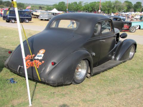 2006 BMW 5 Series - Custom hot rod with a unique pin-up graphic on its rear fender, parked outdoors at a car show.