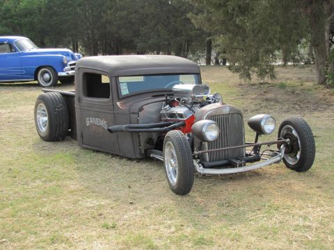 2006 BMW 5 Series - Custom hot rod pickup truck with a large V8 engine and exposed components sits on grass.