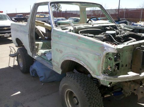 1995 Ford Bronco - This 1980s Ford Bronco is undergoing extensive bodywork, with its paint stripped and parts removed.