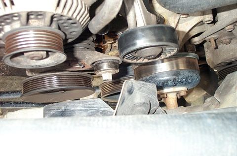 1995 Ford Bronco - Close-up view of engine pulleys and belts, showing signs of age and use.