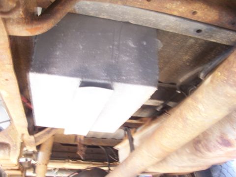 1989 Ford Bronco - This photo shows the underside of a vehicle, focusing on the fuel tank and chassis elements.