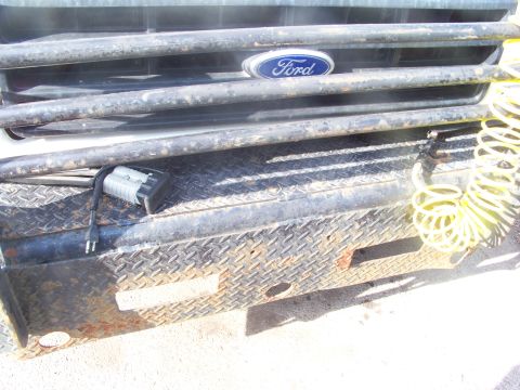 1989 Ford Bronco - Front grille and bumper of a 1989 Ford Bronco, the Ford emblem and a diamond plate finish.