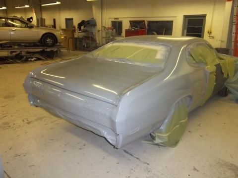 1971 Dodge Dart - A 1971 Dodge Dart is prepped for painting in a workshop, with protective masking covering windows and trim.