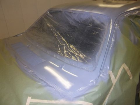 1971 Dodge Dart - A car's windshield and hood are covered in plastic sheeting, indicating preparation for painting or repair work. The image includes a water…