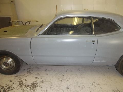 1971 Dodge Dart - Side view of a 1971 Dodge Dart undergoing restoration, showing its body in primer.