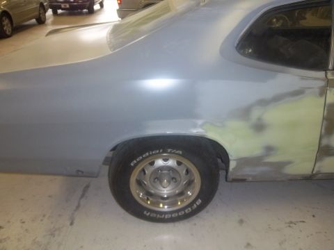 1971 Dodge Dart - Rear quarter panel and door of a 1971 Dodge Dart undergoing bodywork and primer application.