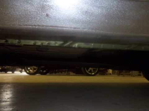 1971 Dodge Dart - Close-up of a car's underside showing a repaired rocker panel with visible welding marks.