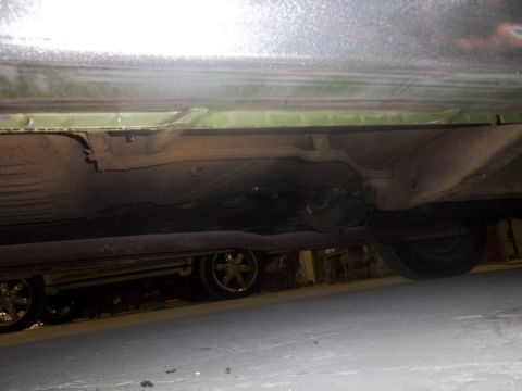 1971 Dodge Dart - The undercarriage of a vehicle is visible, including the frame and suspension components.
