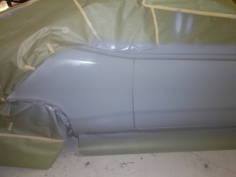1971 Dodge Dart - A car's side panel is prepared for painting, covered in protective materials.
