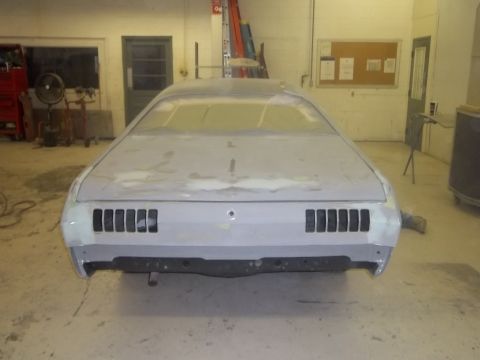1971 Dodge Dart - Rear view of a 1971 Dodge Dart in a body shop, with primer and body filler visible.