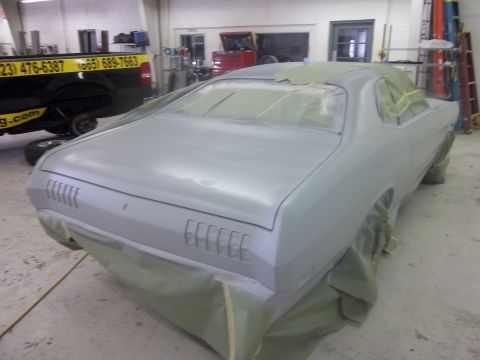 1971 Dodge Dart - A 1971 Dodge Dart coupe is prepped for paint in a workshop, showing its rear end and bodywork.