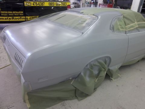 1971 Dodge Dart - A 1971 Dodge Dart is shown in a workshop, covered in masking for paint preparation.