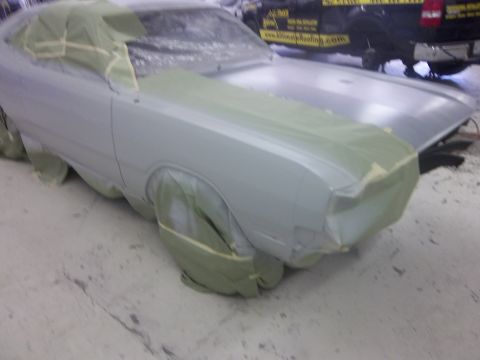 1971 Dodge Dart - A car is covered in protective material, likely for painting, with a truck visible behind it.