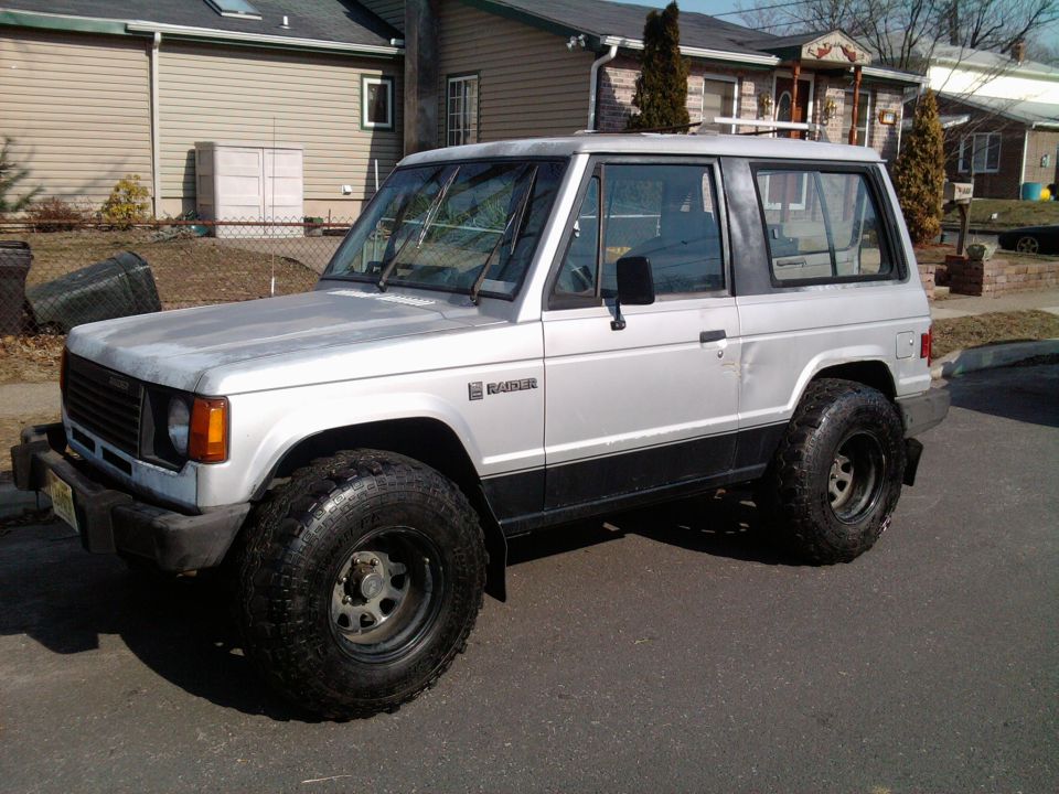 Silver two-door SUV with black trim and large tires. "Raider" badge visible
