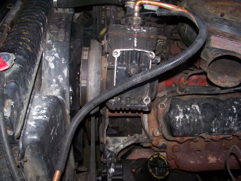 1989 Ford Bronco - Close-up view of the engine compartment, showing various mechanical components and hoses.