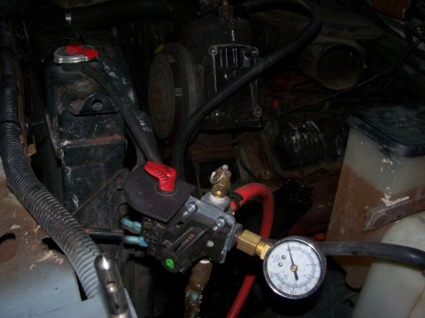 1989 Ford Bronco - Close-up of an engine bay, focusing on a pressure gauge and associated plumbing.