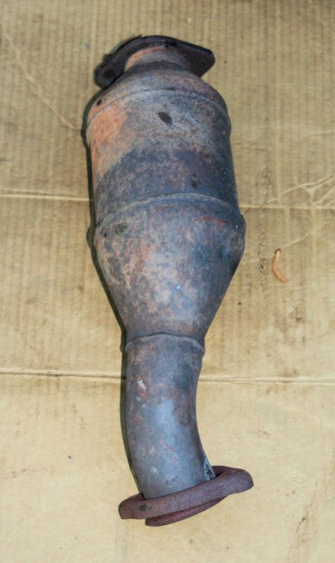 1976 Ford Ranchero - Exhaust catalytic converter with bent pipe and flange, showing signs of rust and wear.