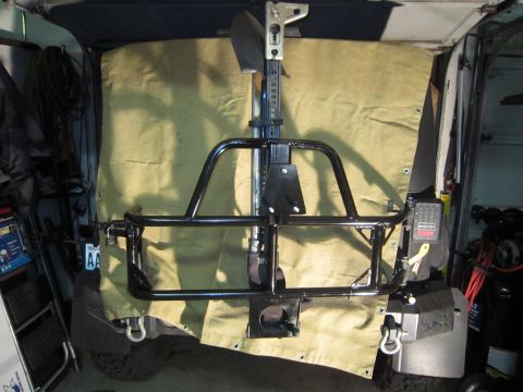 2008 Jeep Wrangler - Aftermarket rear bumper and tire carrier assembly mounted on a vehicle.