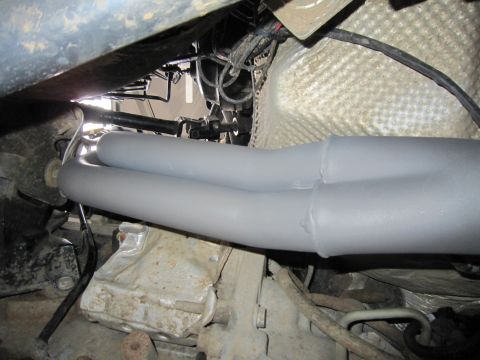 2008 Jeep Wrangler - Close-up view of engine components including exhaust headers and transmission.