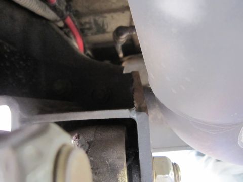2008 Jeep Wrangler - Detail of a welded bracket and exhaust pipe, likely from a vehicle's undercarriage.