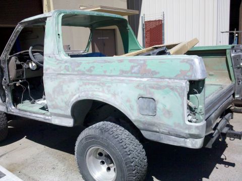 1995 Ford Bronco - This Ford Bronco is undergoing bodywork, with primer visible over the original paint.