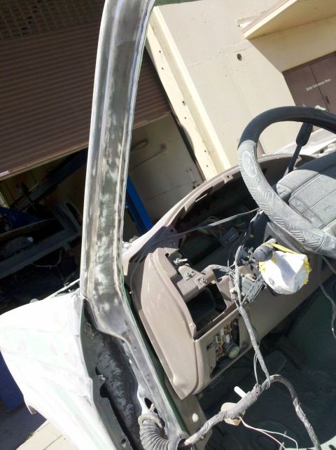 1995 Ford Bronco - Vehicle interior being prepped for paint, with dashboard and steering wheel visible.