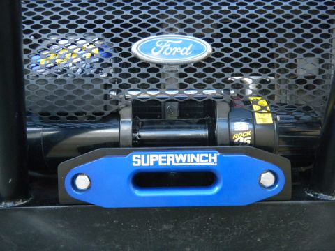 1997 Ford Ranger - Close-up of a Superwinch blue anodized aluminum hawse fairlead bolted to a bumper, with the black winch drum and Rock 95 motor housing behi…