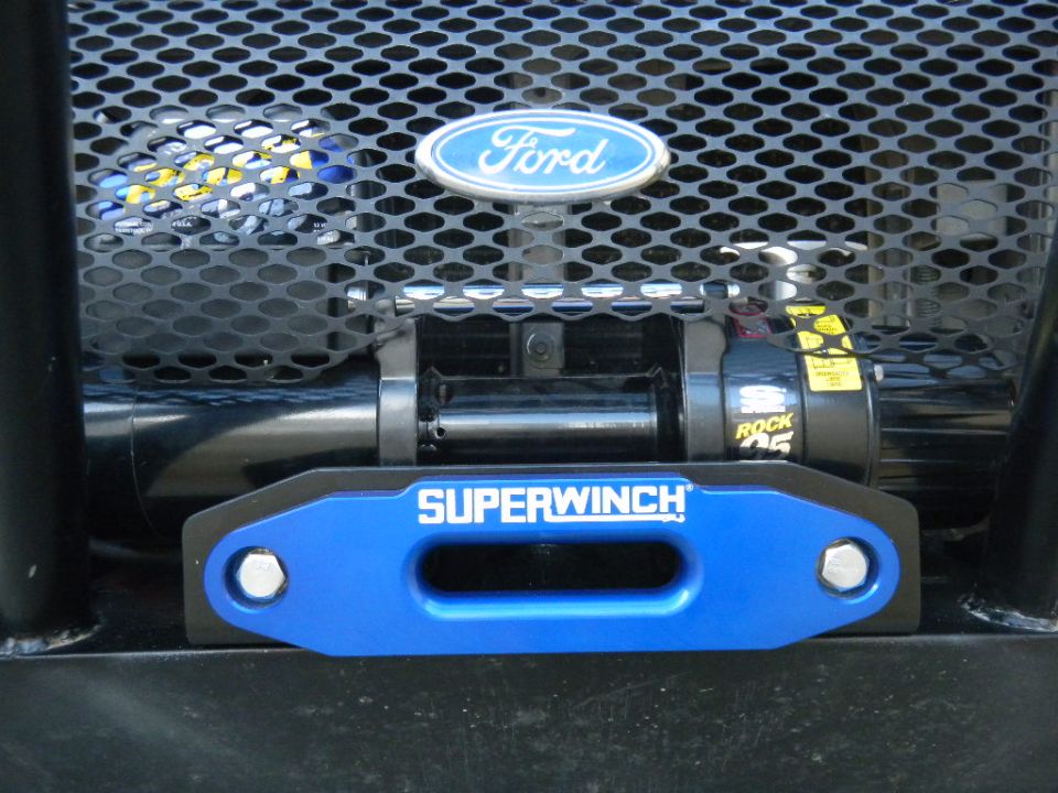 Blue Superwinch hawse fairlead and Rock 95 winch mounted below Ford grille emblem