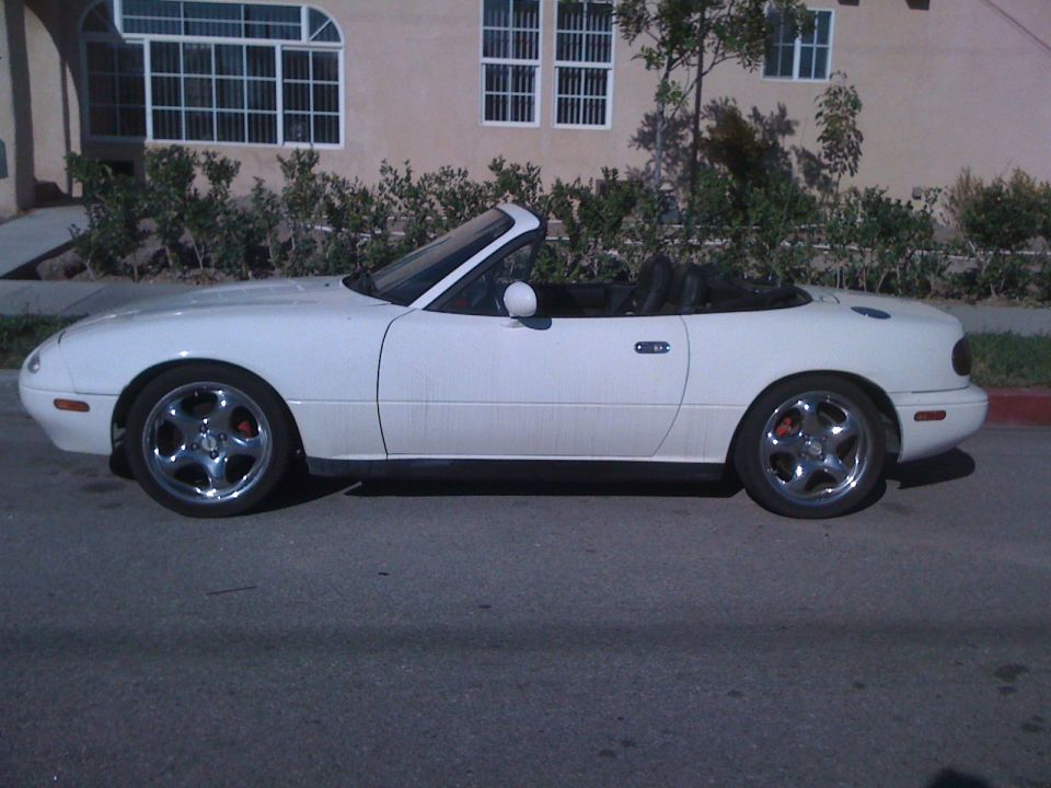 White 1991 Mazda Miata convertible parked curbside