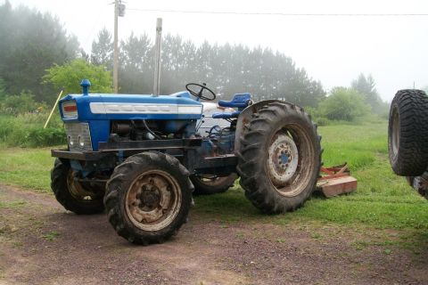 2000 Chevrolet Tahoe - Side view of a blue tractor with large rear tires and a tall exhaust pipe.