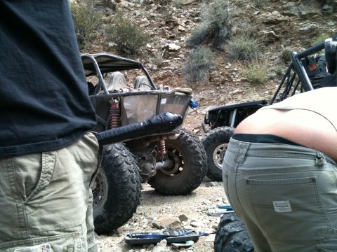1966 Ford Bronco - Off-road buggies are parked on a rocky trail, with people present.