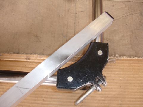 1993 Ford Taurus - A close-up view of a camera mount part attached to an aluminum bar.