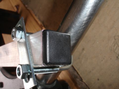 1993 Ford Taurus - Close-up of a metal bracket assembly with bolts and a black cap.