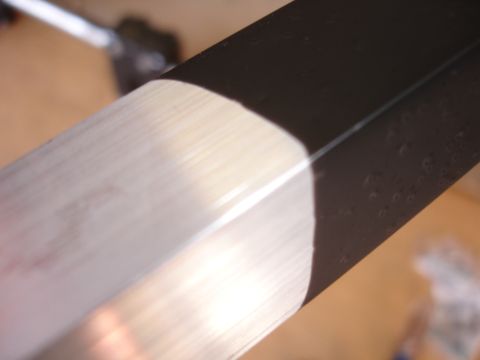 1993 Ford Taurus - Close-up view of a part with black and silver stripes, showing texture and light reflection.