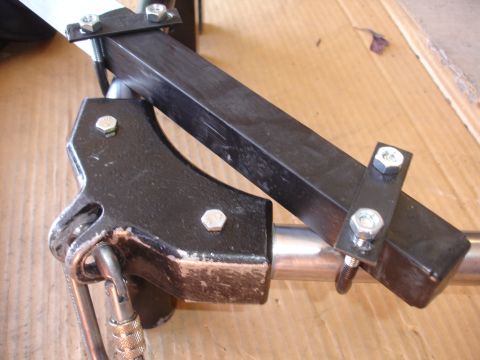 1993 Ford Taurus - A metal bracket system, likely part of a larger apparatus, is shown with various fasteners and a carabiner.