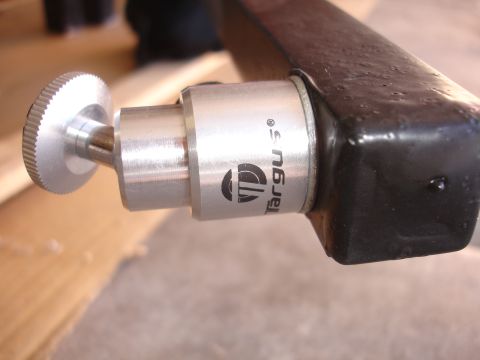 1993 Ford Taurus - Close-up of a camera mount part the Targus logo and a silver knurled adjustment knob.