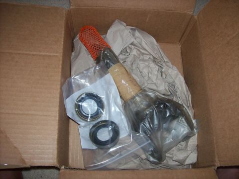 1982 Ford F-100 - New axle and bearing parts are shown inside a cardboard box, ready for installation.