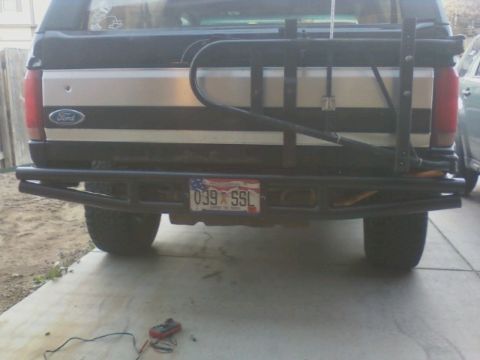 1995 Ford Bronco - The rear of a 1995 Ford Bronco is shown, a custom bumper and a spare tire carrier mounted on the tailgate.