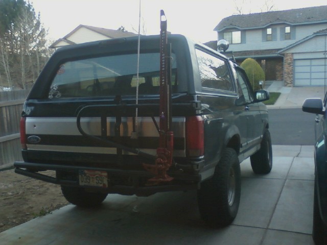 Rear view of a 1995 Ford Bronco with a Hi-Lift jack mounted on the back