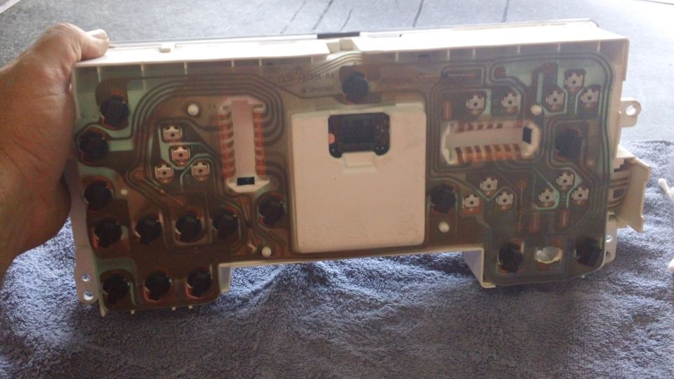 Back of an automotive instrument cluster circuit board with connectors and solder points